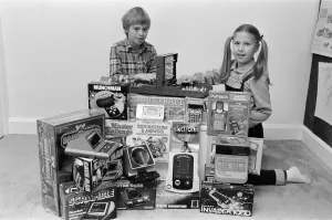 Electronic Prints: Two lucky children surrounded by a selection of electronic games available in the shops