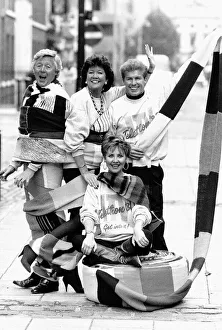Lulu pop singer sitting on a 15 mile scarf being knitted all over the country by