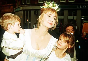 Lysette Anthony actress at wedding with page boy and bridesmaid