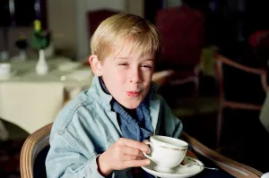 Macaulay Culkin sips his tea as he toasts his membership of he million-dollar-a movie
