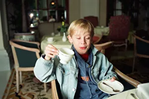 00456 Prints: Macaulay Culkin sips his tea as he toasts his membership of he million-dollar-a movie