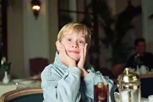 00456 Prints: Macaulay Culkin sips his tea as he toasts his membership of he million-dollar-a movie