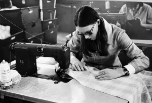 Machinist Lynn brown sews pockets onto a skirt during her shift at a textiles factory