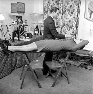 00061 Prints: Magician Bernard Hughes: Performing a levitation trick on his female assistant