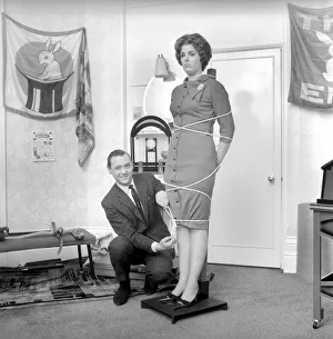 00844 Prints: Magician Bernard Hughes performing rope trick with female assistant. April 1965 A1116b