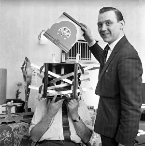00844 Prints: Magician sawing man in half also performing the swords in a box trick