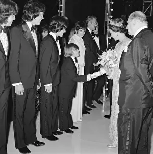Her Majesty Queen Elizabeth II, escorted by Media mogul Lew Grade (right)