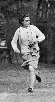 Exercise Prints: Her Majesty Queen Elizabeth II races after one of her pet corgis as she exercises them