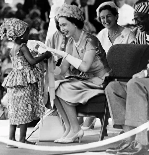 Her Majesty Queen Elizabeth II receives a bouquet with ribbons from Mamawo Kaikai