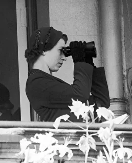 Binoculars Prints: Her Majesty Queen Elizabeth II watching her horse in action through a pair of binoculars