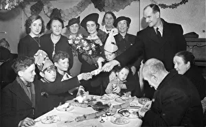Dinner Prints: The Major of Bootle, (Mr Alderman Js Kelly) pulling a cracker with one of the children