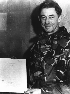 Major General Jeremy Moore holds the surrender document signed by General Mario Menendez