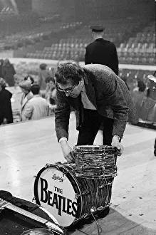 Mal Evans dismantles Ringo Starrs drum kit after the concert in Washington DC during