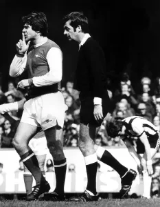 Malcolm MacDonald signals to Liam Brady April 1978 to keep quiet after a small
