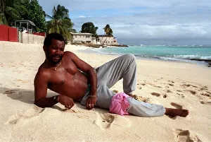 00272 Prints: Malcolm Marshall West Indies cricketer relaxes on a sandy beach in Barbados 5th February