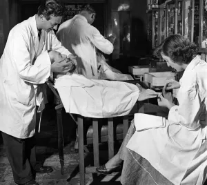 Male Grooming : Barbers. A customer having a Shave and a manicure at Cliffords