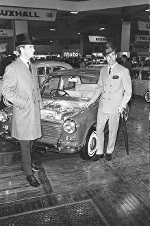 Male Models pose with Austin Mini cars at the British International Motor Show in London