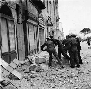 01459 Collection: Maltese police helping to clear debris after an air raid. March 1942