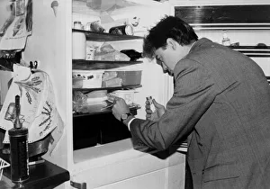 00199 Prints: A man applies a swab test as he checks his fridge for bugs march 1991