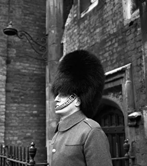 A man of the Coldstream Guards on duty outside Buckingham Palace wearing the traditional