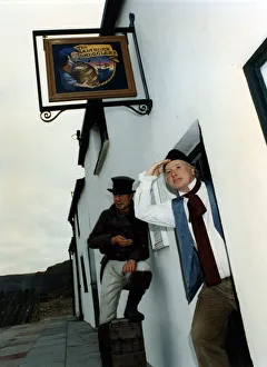 Seaside Town Prints: A man in costume poses outside Saltburn Smugglers Heritage Centre. 6th December 1991