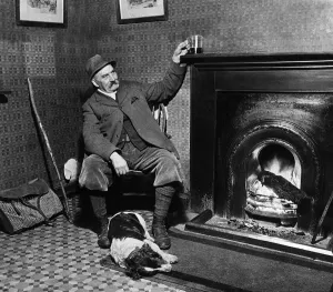 Country Prints: Man and his Dog - March 1935 A game keeper relaxes with his drink by the fire