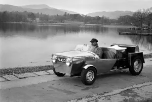 Man driving a steam powered out in the countryside December 1970