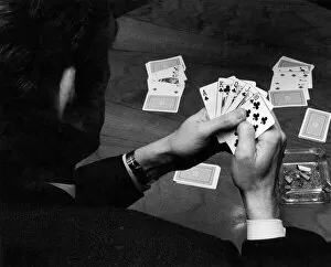 Images Dated 2nd February 1972: A man holding his hand of cards, a royal flush, while playing poker. February 1972