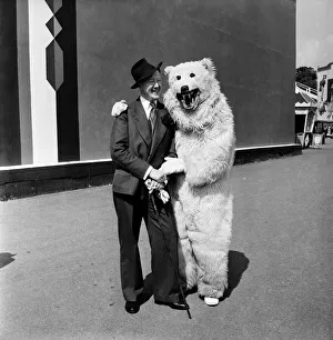 Man with man in bear costume at Battersea fun fair June 1952. August 1952 C2976-002
