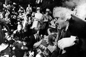 A man is some medieval stocks waiting to be hit by eggs on 11th December 1973