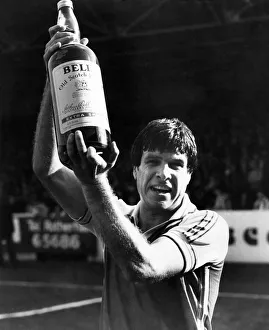 00250 Prints: Man of the month - Emlyn Hughes picks up a gallon of scotch while his former mates