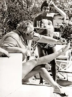 Confusion Prints: Man painting toe nails - deceptive angle makes it look like man is painting his