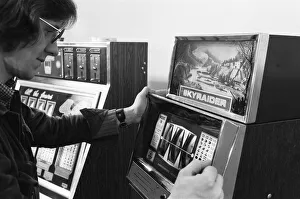 Man playing a one arm bandit slot machine in a London amusement arcade. 8th January 1975