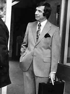 Briefcase Prints: A man posing in a new suit from the Jonathan Hutton range with the latest in sideburns