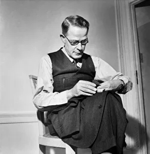 00013 Prints: Man sewing on button Harry Leonard - Winner of National sewing Competition