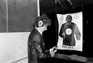 A man shooting at a target during practice at Gun City shooting range in South Africa