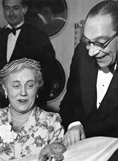 00025 Prints: Man showing off a chicken drumstick to a woman at a dinner party Circa 1955