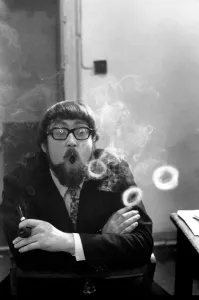 A man smoking a cigarette blowing smoke rings. November 1969 Z12004-001