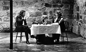 A man and woman enjoying a glass of wine, seated at a dinner table in one of