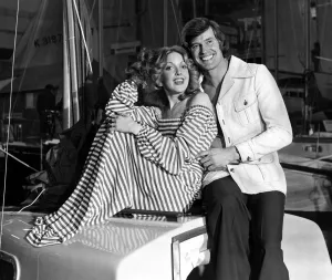Stripes Prints: Man and woman posing together on a boat. he is wearing a washable safari jacket with