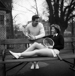 00008 Prints: Man and woman talking on a park bench after enjoying a game of tennis January