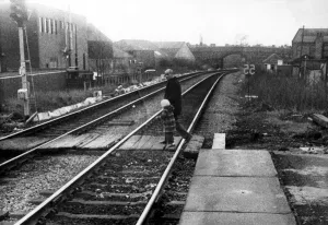 00369 Prints: A man with a young child illegally crossing the railway line at West Jesmond Station