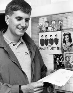 Manager Paul Thompson in the groups office with Housemartin images behind him