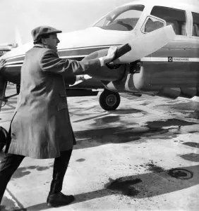 00053 Prints: Managing Director Freddie Laker (40) pushes his own aircraft back off the airfield apron