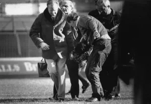 Manchester City player Paul Lake is stretchered off after being knocked unconscious by a