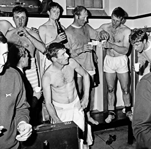 00943 Prints: Manchester City players celebrate with champagne in the dressing room after sealing