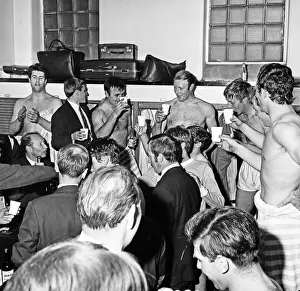 00943 Prints: Manchester City players celebrate with champagne in the dressing room after sealing