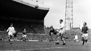 Manchester United on the attack with a flying header during their league match against