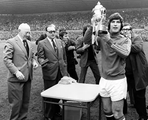 01216 Prints: Manchester United captain Martin Buchan April 1975 holding the 2nd Second