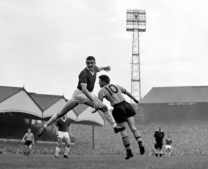 Manchester United defender Bill Foulkes jumps up for a high ball with Broadbent of